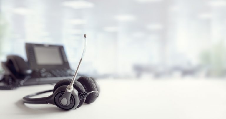 Headset headphones telephone on desk in call centre